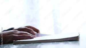 Elementary school student reading book Young girl studying her text book in class, close-up plan