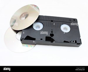 DVD disks and VHS video the cartridge on a white background in time and technology comparison Stock Photo - Alamy