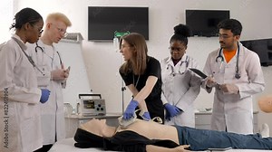 Instructor teaching first aid cardiopulmonary resuscitation course and use of automated external defibrillator workshop