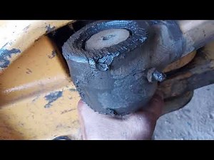Replacing the bushing and pin on the swing cylinder of a New Holland b95b.