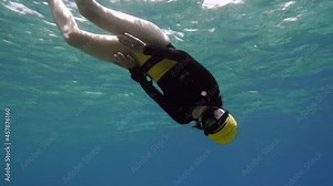 Pretty Free diver girl enjoying sea world. Freediving is a sport when a person dives into sea water while holding his breath. An extreme type of underwater diving to a depth without professional