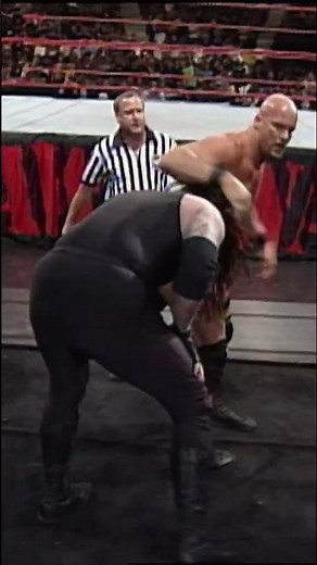 Undertaker sends “Stone Cold” Steve Austin crashing on top of the steel ramp