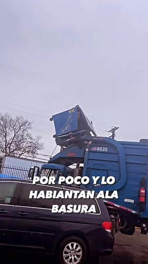 Blue Garbage Truck in Action: Urban Waste Collection