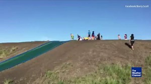 1.7M views · 23K reactions | It’s hot in Queensland, Australia, so a farmer rolled a tarp down a hill and turned it into one big water slide. | The Weather Channel | Facebook