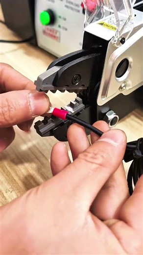Crimp jaws close red terminal locks wire holds firm