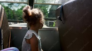 School girl riding in academic shuttle. Public education transportation. Slow motion. Close up