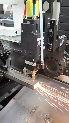 cutting the brown metal hollow bar using an automatic cnc laser machine