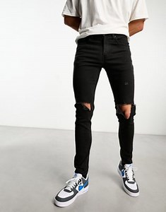 Levi's Skinny tapered fit jeans in black with knee rips | ASOS
