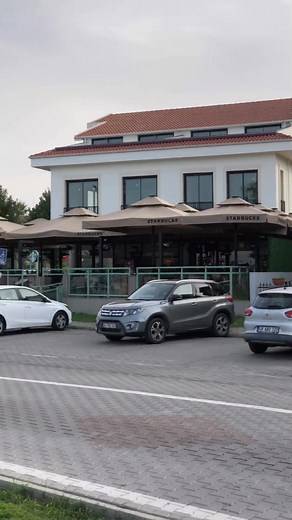 ☕ A great roadside stop in Fethiye, Turkey! 🇹🇷 This video captures a quick glimpse of life along the street, featuring a Starbucks and the nearby Mancero Kitchen Bar. Don't miss the bright blue bike path and the view of the mountains in the distance! • Spot the: Starbucks, Mancero Kitchen Bar, and the vibrant blue bike lane. • Location: Fethiye, a beautiful coastal town. Which Fethiye spot would you grab a coffee at first? ⬇️ #calisbeachinternational #fethiye #turkey #turkiye | Calis Beach Int