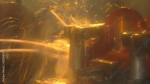 Lathe. drilling bushing. operator machining mold and die part by CNC turning machine in factory. Milling metalworking process. Coolant and lubrication