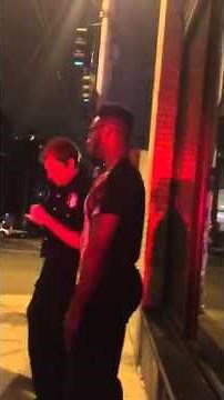 "Phoenix Jones" talks with Seattle police officers after breaking up alleged armed assault