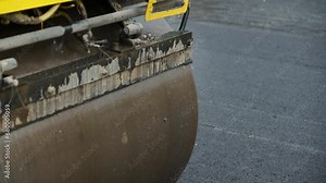Process of asphalting road construction infrastructure by compressing, compacting, leveling and smoothing the asphalt road surface using a tandem roller