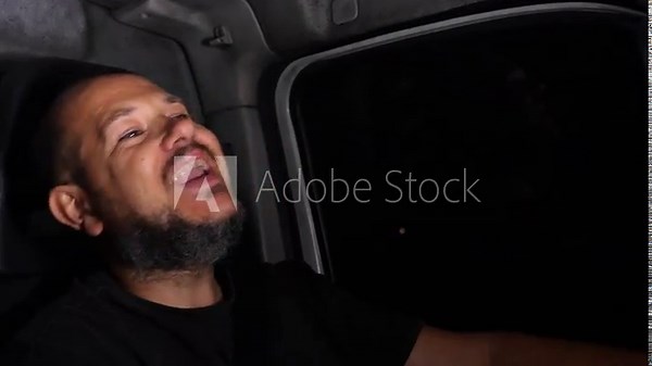 Delivery driver sings while driving at night to stay awake during long hours. The scene highlights fatigue management and human behavior.