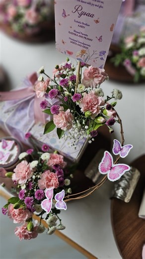 Wrap Love Repeat | Gifting on Instagram: "Magical announcement favors for a Baby girl! 🩷✨️ Butterflies and florals to welcome the little one. In love with these custom made multipurpose wooden platters on which we placed @doft.candles and @entisichocolatier #babygirl#babygirlhampers#babygirlannouncement#luxurygifting#bespokepacking#announcementfavors"