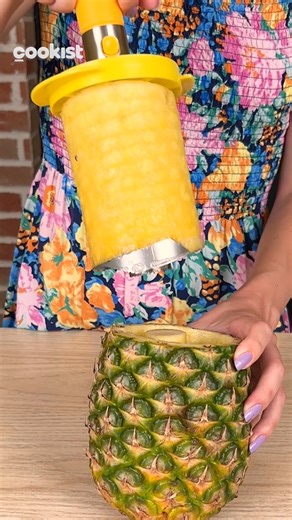 How to cut a pineapple in under 5 minutes and make a delicious fruit salad! Here's a very simple way to cut a pineapple and create a delicious fruit basket! Cut the top off of the pineapple. Hollow out the pineapple completely and fill it with fruit pieces. We used a pineapple opener that you can find on Amazon by searching for Stainless Steel Pineapple Cutter | Cookist Wow