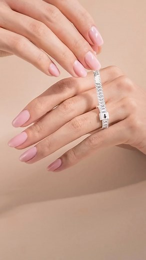 Need an easy and accurate way to find your ring size at home? Our free ring sizer is simple and quick to use. 💍📏 Just place it around your finger like a belt, tighten it until you get a comfortable fit, and read off your size! Visit us at https://www.kirkkara.com/pages/ring-size-guide to learn more! | Kirk Kara