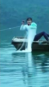 a village lady catching fish by net in river