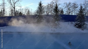 thermal underground hot spring open-air pool water evaporates the moisture and gives off heat frosty winter day