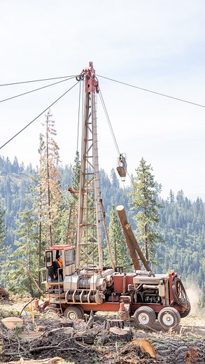 Extraction of harvested trees on steep slope logging operations often requires specialized machines called yarders. These pieces of equipment are equipped with drums of wire rope which are rigged through the harvest block. - Skyline carriages run along and are moved by these cables and provide a means to secure logs for extraction. Logs are commonly secured using grapples directly on the carriage or by wire rope chokers attached to the mainline or skidding line which passes through the carriage 