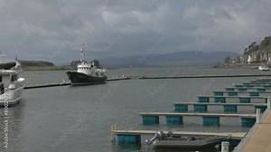 Hand-held shot of yachts and ships docked in the marina in Oban, Scotland
