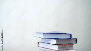 Rotating Stack books for reading on desk white background. Research literature for learning education concept. 4k