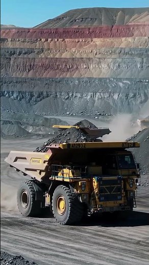 🌄 Majestic Mining: A Giant Haul Truck Against a Layered Cliff! 🤩