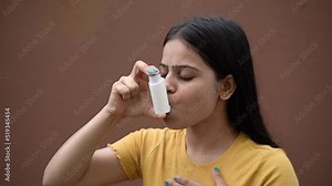 Asthmatic patient catching inhaler having an asthma attack. Young woman having asthma, chronic obstructive pulmonary disease