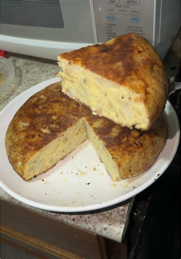 Yummy breakfast 😋😋 Boil some sliced/diced potatoes as well as sliced onions (in a pot of oil) Remove when tender and put into your whisked eggs (make sure it's enough I used 8 eggs) Season well and pour onto the pan (don't use too much oil like I did) Make sure heat is on medium low so that it doesn't burn. Put top on and let it cook. Then you will have to flip over (this part will make or break the look so be careful). Once flipped put top on and let it cook until ready! You can eat with brea