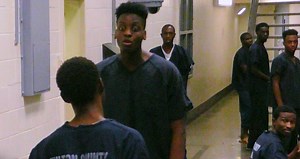 When pod boss "Too Tall" gets frustrated with another inmate, who he believes is making false claims about his gang affiliation, he gangs up on him with five other men in this flashback scene. | 60 Days In on A&E