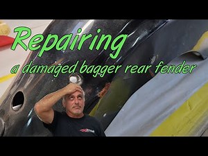 Doing auto bodywork on a creased and dented Harley motorcycle fender