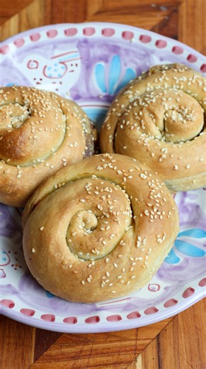 Tiropita strifti with mint, dill and orange. Hand rolled Greek cheese spirals made with a simple olive oil dough and a creamy feta and ricotta filling. Fresh mint and dill keep the filling light, while a little orange zest lifts the richness of the cheese. Baked until deeply golden and finished with sesame, these are crisp on the outside with a soft, savoury centre. Perfect for lunch, entertaining or part of a shared mezze table. The full step by step recipe with detailed dough, filling and shap
