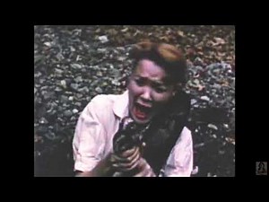 Mary Munday wrestles a reticulated python.