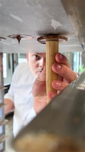This is how the little hats of the Apricot Chocolate are made By @bijrobert The cake features a base of biscuits and pieces of caramel, Sacher biscuit, and a delicate balance of apricot and dark chocolate. It is also available as an individual pastry. | Simplistic Food