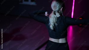 Live camera. Dancing woman. Close-up of active arm waving and gestures while performing the Waacking dance in a neon light hall Stock Video