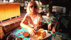 SLOW MOTION: El Pueblo de Los Angeles State Historic Landmark, California, United States. Happy tourist woman drinking Margarita. Oldest part of Downtown