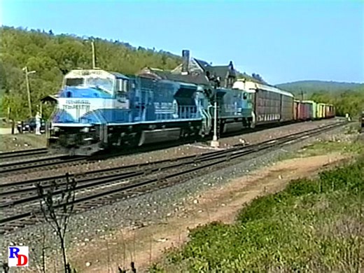 A pair of shiny new SD80MACs passes by the old depot at Palmer, Massachusetts. The depot would become and still is the location of a successful restaurant. From the BKVP show "Conrail SD80MACs on the Boston Line" https://rfd.video/SD80MAC | Railfan Depot
