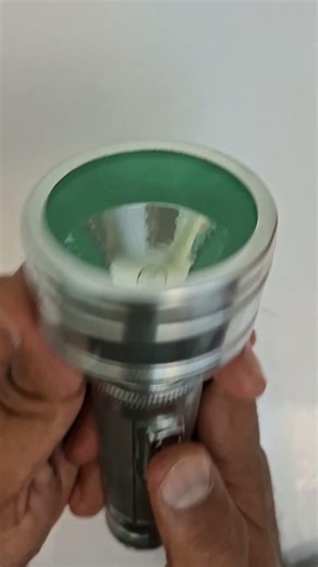 Old time hand torch inserting cell and turning it on