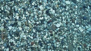 Water surface texture. Top view seabed with pebbles. Water caustic background. Ripples and waves