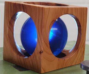 Artist Turns a Resin Sphere Inside a Wooden Cube