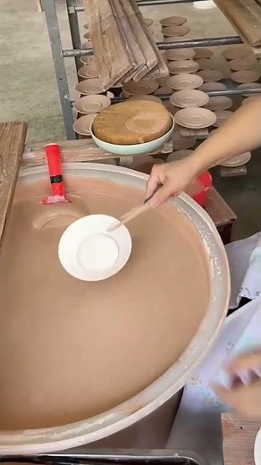 the process of dipping small plates into a special liquid made from clay