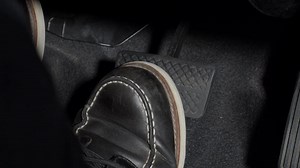 Accelerate and Brake. Foot pressing foot pedal of a car to drive ahead. Accelerator and brake pedal in a car. Driver driving the car by pushing accelerator pedals of the car. inside vehicle automobile