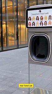 A stunning young American girl steps up to this futuristic hair-braiding machine! She chooses an African braid style from the menu, bends forward, and places her head fully inside the device. #creatorsearchinsights #fyp #haircut #ai #millionviews | Thinktato