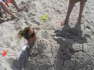 Aishling buried in sand at Clearwater