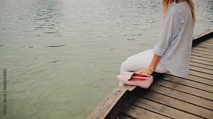 Pretty girl posing on a lake shore.