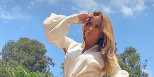 Jennifer Lopez Stuns in an Orange Skirt With a Thigh-High Leg Slit and Gold Platform Boots