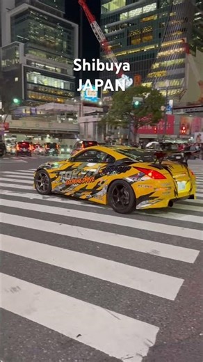 Smart cars passing through Shibuya. Tokyo, Japan.