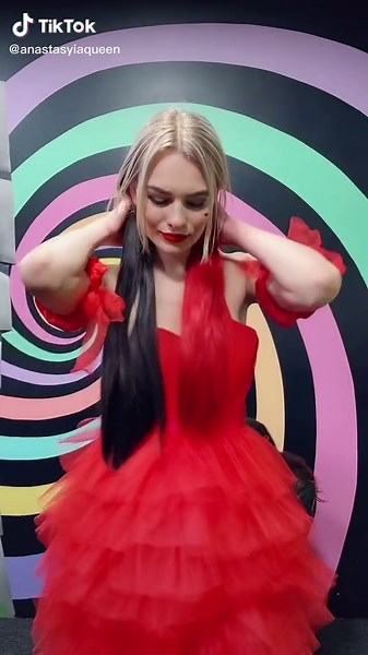 Enchanting Red Dress Modeling in Vibrant Spiral Background