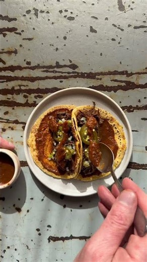 Plating Our Braised Beef Cheek Tacos on Fresh Corn Tortillas.