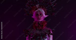 Fantasy floral elf fairy female posing in creative lighting. Body painting fashion project. Model and property released. 4K UHD RAW FOOTAGE
