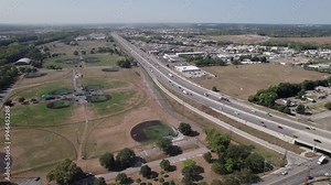 Drone shot and aerial establishing view of interstate 71 south from Columbus, Ohio with traffic moving past Cleveland and towards Cincinnati at 70 mph with cars and semi trucks speeding on multi-lane